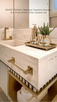 a bathroom sink with gold faucets on it