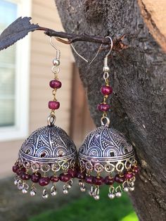 Ruby & Silver Jhumka Earrings Jhumkas are the calling on the runway ramps this year. This is a traditional artist Jhumki handmade with love.  Finished up with beautiful deep red rubies, almost maroon drops in color. A very hot pair for this season. I have made it again as I received many requests to do so. The length of the earrings is  3 inches from top to the tip of the earring. Earring Dome base metal is silver plated brass Earring Hook - .925 Sterling silver Rubies are naturally mined rubies Metal Chandelier Earrings With Latkans In Temple Jewelry Style, Handmade Silver Temple Jewelry Chandelier Earrings, Nickel-free Festive Jewelry, Handmade Silver Fusion Style Jhumkas, Bohemian Drop Jhumkas In Metal, Handmade Silver Fusion Jhumkas, Bohemian Sterling Silver Drop Jhumkas, Temple Jewelry Festival Earrings With Latkans, Sterling Silver Bohemian Jhumkas