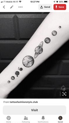 an arm tattoo with planets on it