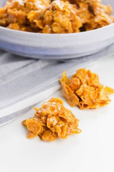 a white bowl filled with granola next to a napkin