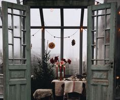 an open door leading into a dining room with christmas decorations on the table and outside