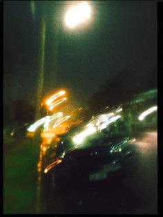 blurry photograph of cars driving at night