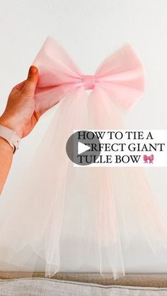 a person holding a pink bow with the words how to tie a rectangle tulle bow