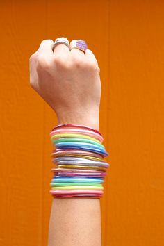 Beautiful and rainbowy, these bracelets are perfect for everything: from working on your chakras to coordinating with your favorite outfit and everything in between! ✨The Magic is in the Details✨Quantity per order: 10 BraceletsColor: Red, Orange, Yellow, Green, Aqua, Blue, Violet, Silver, Rose Gold, Yellow GoldApprox. Size: 2.75" internal diameterThese will come to you tied with a ribbon, as show in the images. As you roll on these lucky bangles, set an intention for your day, and when their spa Page Boy Outfits, Burgundy Flower Girl Dress, Jelly Bracelets, Glitter Rainbow, Lucky Colour, Burgundy Flowers, Waterproof Jewelry