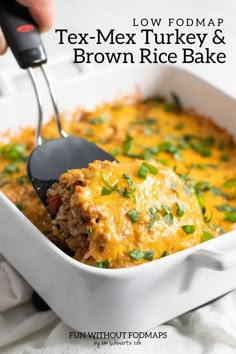 a close up of a spoon in a casserole dish with text overlay reading low fodmap tex - mex turkey and brown rice bake