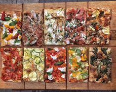 eight different types of pizza on wooden boards