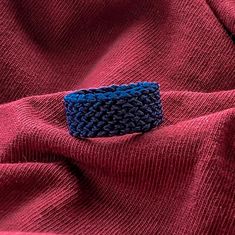 a close up of a red cloth with a blue ring on it's end