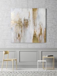 an abstract painting hangs on the wall next to two chairs and a table in front of it