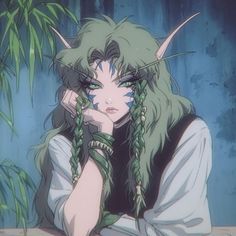 a woman with green hair and horns sitting in front of a plant