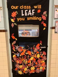 a door decorated with fall leaves and the words, our class will leaf you smiling