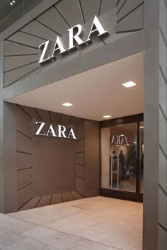 an entrance to a store with the name zara on it