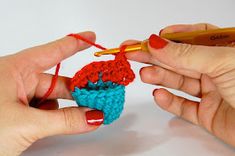 two hands holding crochet together to make a small cupcake ornament