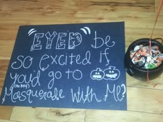 a chalk board with writing on it next to a bowl of candy and string wrapped in twine