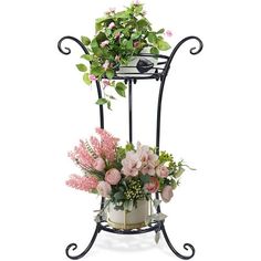 a potted plant on a stand with pink flowers and greenery in the corner