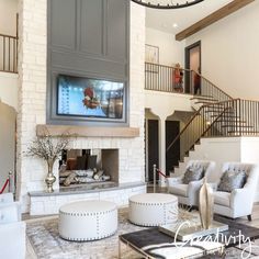 a living room filled with furniture and a flat screen tv mounted to the wall above a fireplace