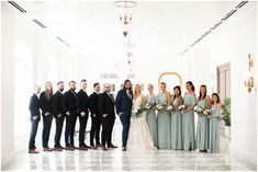 a group of people standing next to each other in front of a white wall and ceiling