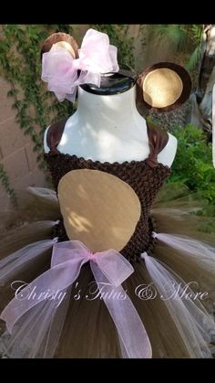 a dress made to look like a teddy bear wearing a hat and tutu skirt