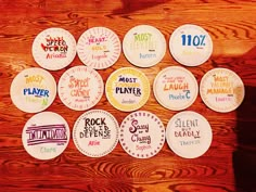 paper plates with different logos on them sitting on top of a wooden table in front of a wood paneled wall