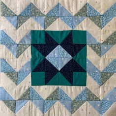 a blue and white quilted wall hanging