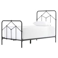 an iron bed frame with white sheets and pillows on it, against a white background