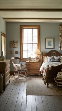 a bedroom with blue walls and wooden floors