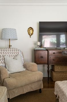 a living room with a couch, chair and television