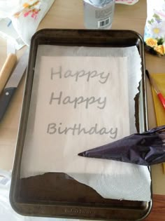 a birthday cake with an umbrella on it sitting on a table next to other items