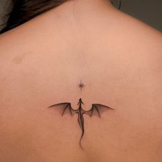 a woman's back with a tattoo on it