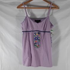 Nwt Inc International Concepts Purple With Embroidered Flowers Hanging From Bustling Sz M And L. Adjustable Shoulder Straps. Approximate Measurements: Sizes. M L Pit - Pit Across. 16" 17" Pit - Hem. 17.5" 18" Waist Across. 18" 20" Ab - 43. Ab - 44 Summer Embroidered Cotton Tank Top, Summer Cotton Embroidered Tank Top, Embroidered Fitted Tank Top For Spring, Fitted Embroidered Tank Top For Beach, Fitted Embroidered Tank Top For Spring, Embroidered Cotton Camisole Top, Cotton Sleeveless Camisole, Summer Embroidered Camisole Tank Top, Cotton Cami Tank Top With Floral Embroidery