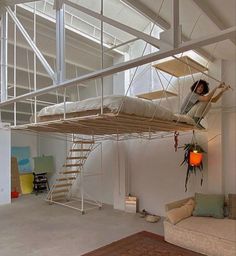 a living room with a couch and a loft bed