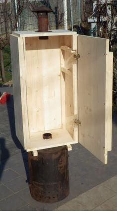 a wooden box sitting on top of a trash can