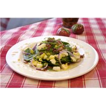 a white plate topped with vegetables on top of a red and white checkered table cloth