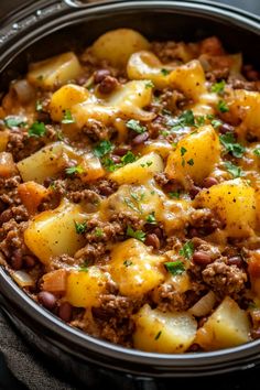 a casserole dish with potatoes, meat and cheese