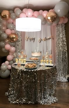 a table topped with lots of desserts and balloons