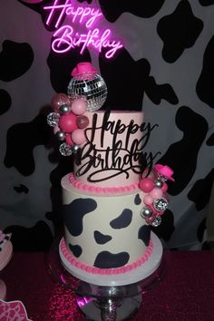 a birthday cake with pink and black decorations