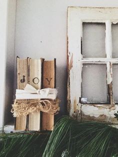 an old window and some books on a shelf