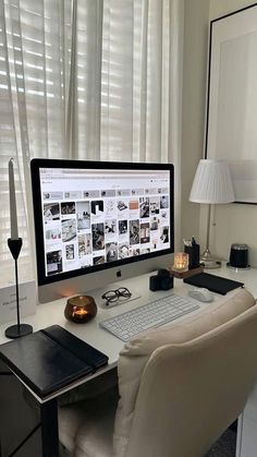 a computer monitor sitting on top of a desk next to a keyboard and mouse in front of a window