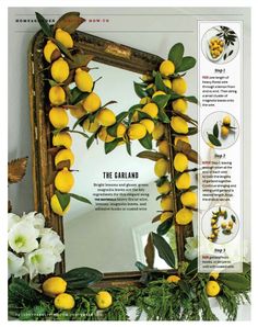 a mirror with lemons hanging on it and flowers around the frame in front of it