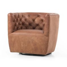 a brown leather chair sitting on top of a white floor