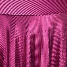 a close up of a pink table cloth