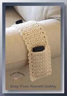 a crocheted cell phone holder sitting on top of a couch