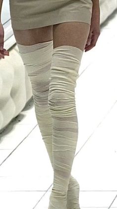 a woman wearing knee high socks and stockings