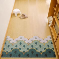 a pair of shoes is on the floor in front of a bookcase and rug