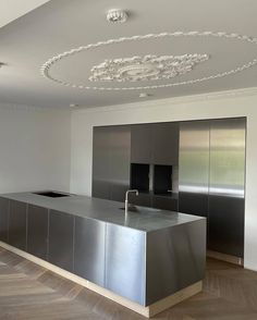 an empty kitchen with stainless steel appliances and cabinets