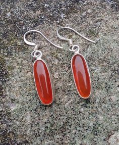 Lovely oval shaped Carnelian and Silver Earrings, Dangle Oval Carnelian Earrings, Valentine's Day and Birthday Gift for her Dimensions (approx): Length: 3.8 cm including hook Carnelian: 2 cm x 0.8cm Materials: * 925 sterling silver (hallmarked) * Natural Carnelian In JewelleryArtgGallery you can find tasteful and unique jewellery that is influenced by various cultures and traditions. All items are handmade and embolished  by natural gemstones. Therefore, please allow for slight variations in size and colour. Carnelian Earrings, Long Silver Earrings, Carnelian Jewelry, Lovely Earrings, Etsy Earrings Dangle, Birthday Gifts For Her, Natural Gemstones, Silver Earrings, Jewelry Earrings Dangle