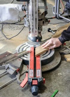 a person using a circular saw to cut wood