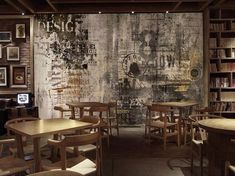 a restaurant with wooden tables and chairs in front of a wall covered in bookshelves