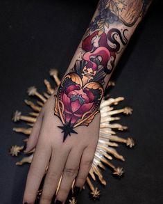 a woman's hand with tattoos on it