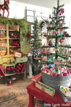 a christmas tree is in the middle of a room filled with ornaments and other holiday decorations