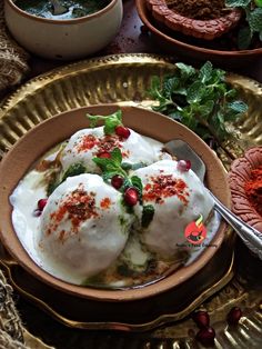 two bowls filled with ice cream and garnished with pomegranates